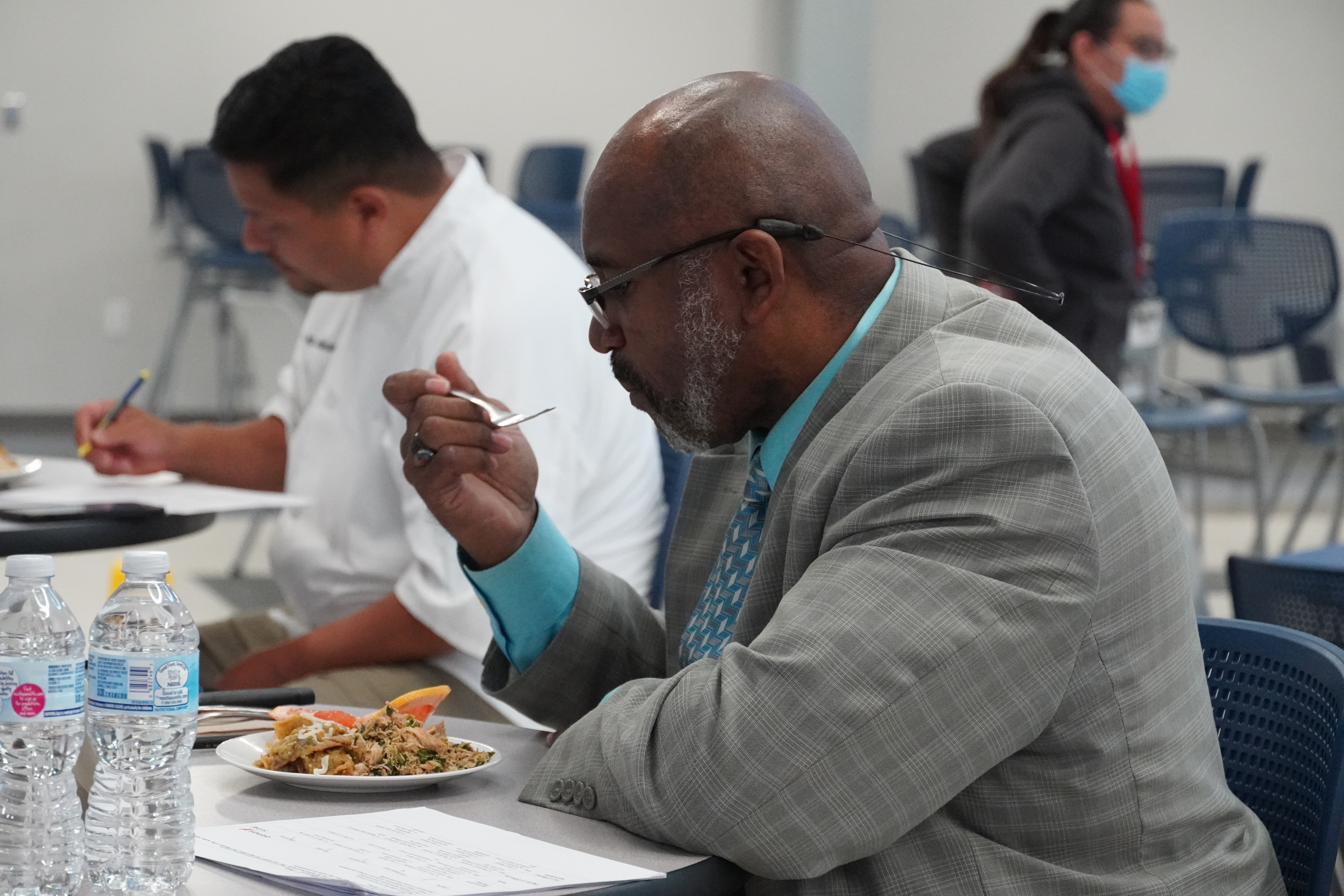 Dr. Anthony Price tastes food for judging